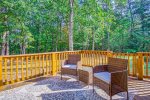 Furnished deck in wooded setting